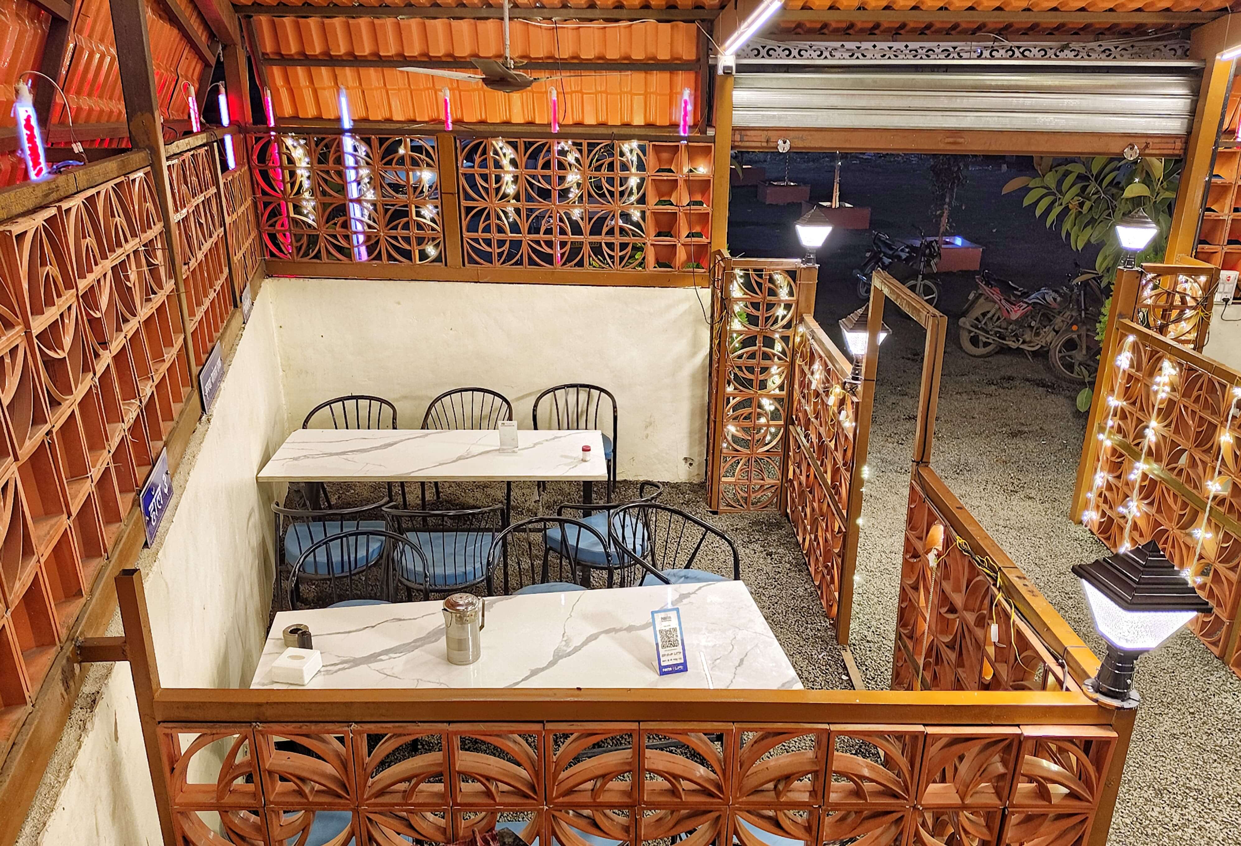 Lit indoor walkway at night between booths